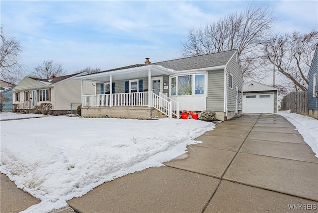 view of front of home with a garage, an outdoor structure, and covered porch