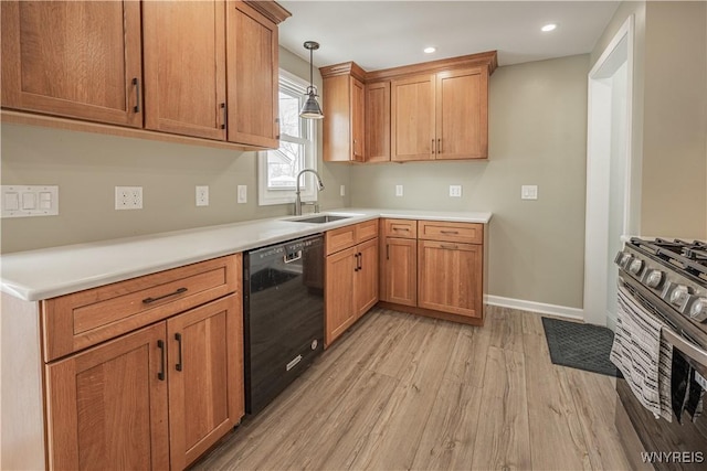 kitchen with pendant lighting, sink, light hardwood / wood-style flooring, dishwasher, and stainless steel range with gas cooktop