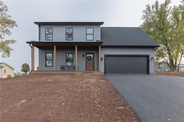 view of front facade with a garage and covered porch