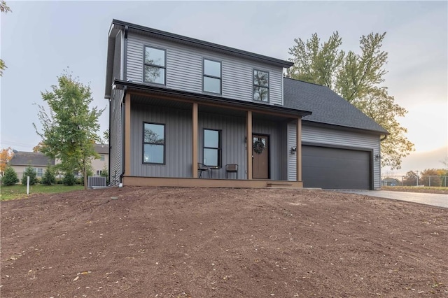 contemporary home featuring a garage and covered porch