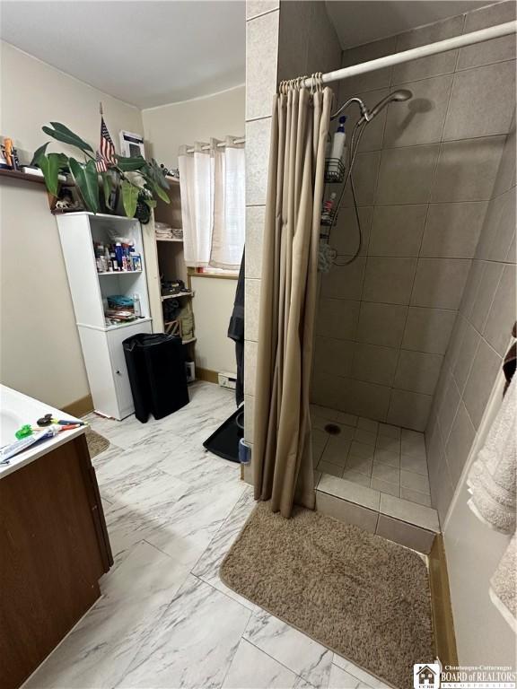 bathroom with walk in shower and vanity