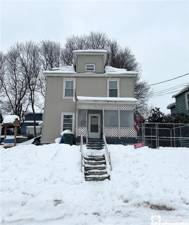 view of snow covered back of property