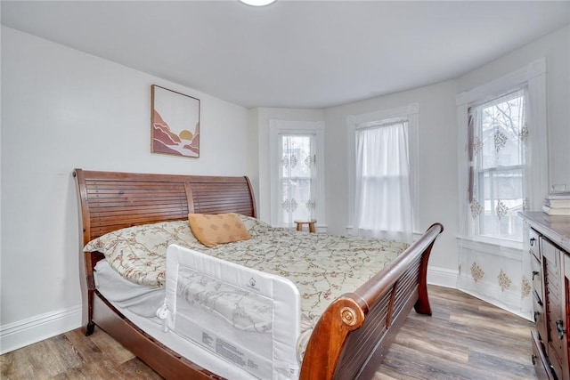 bedroom with hardwood / wood-style flooring