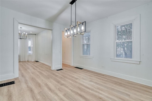 unfurnished dining area featuring light hardwood / wood-style flooring