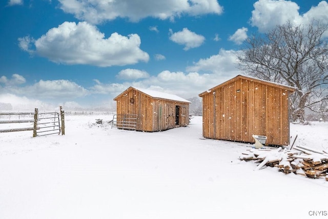 yard covered in snow featuring an outbuilding