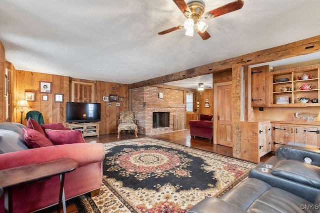 living room featuring ceiling fan, wood finished floors, and wooden walls
