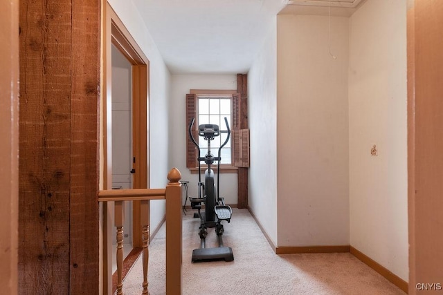 workout room featuring baseboards, attic access, and carpet