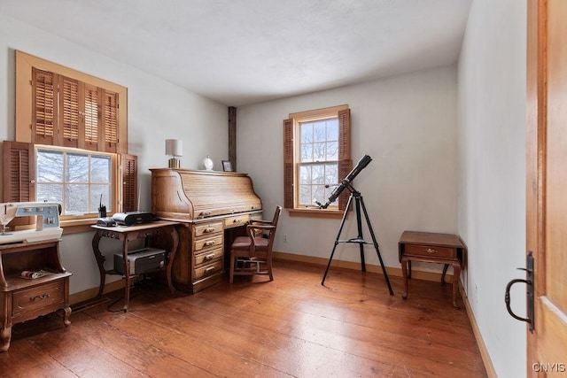 office space featuring baseboards and wood-type flooring
