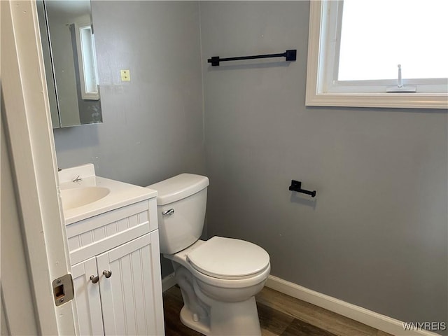 bathroom featuring vanity, hardwood / wood-style flooring, and toilet