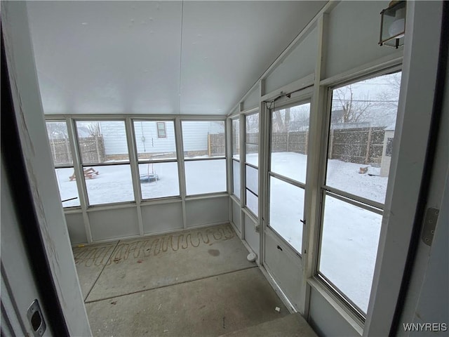 unfurnished sunroom featuring lofted ceiling