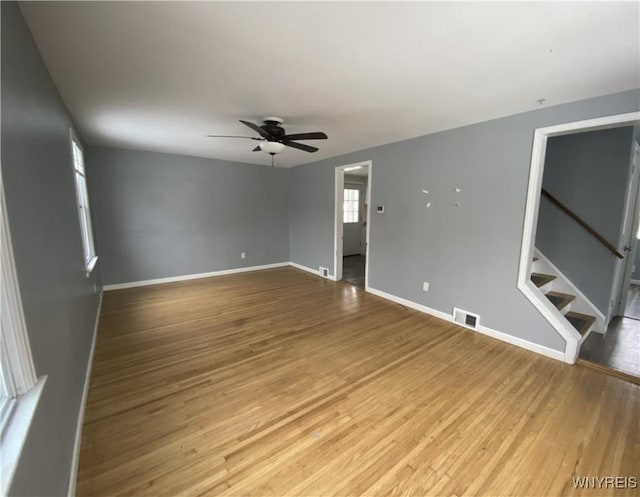 empty room with light hardwood / wood-style flooring and ceiling fan