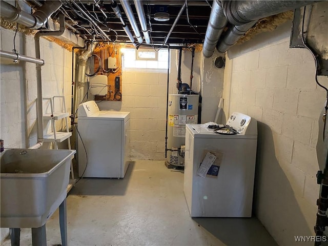 basement featuring separate washer and dryer, sink, and gas water heater