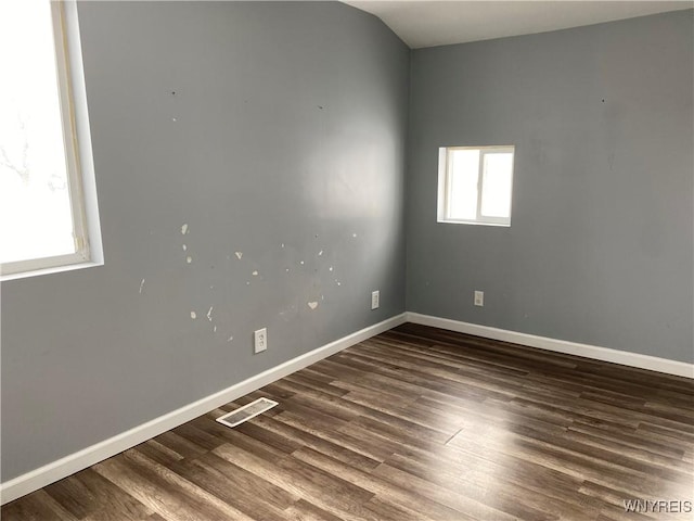 unfurnished room featuring dark wood-type flooring