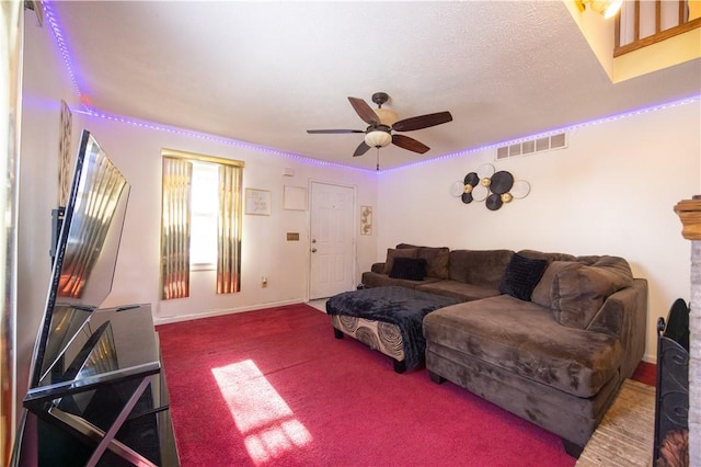 living room featuring ceiling fan, a textured ceiling, and carpet flooring