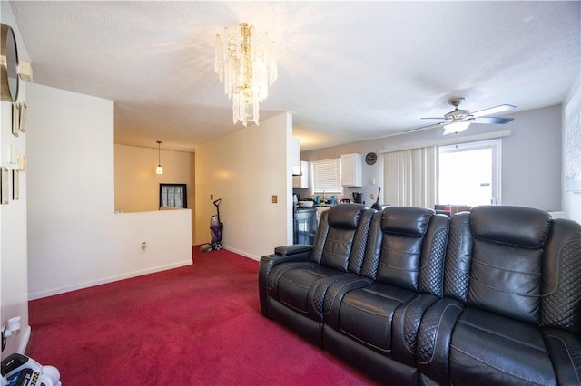 living room with ceiling fan with notable chandelier and carpet floors