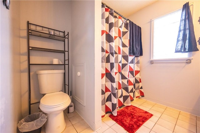 bathroom with walk in shower, tile patterned floors, and toilet