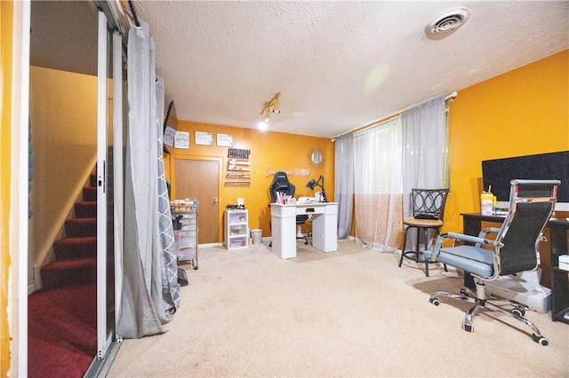 office space with carpet floors and a textured ceiling