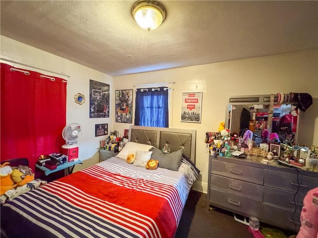 carpeted bedroom featuring a textured ceiling