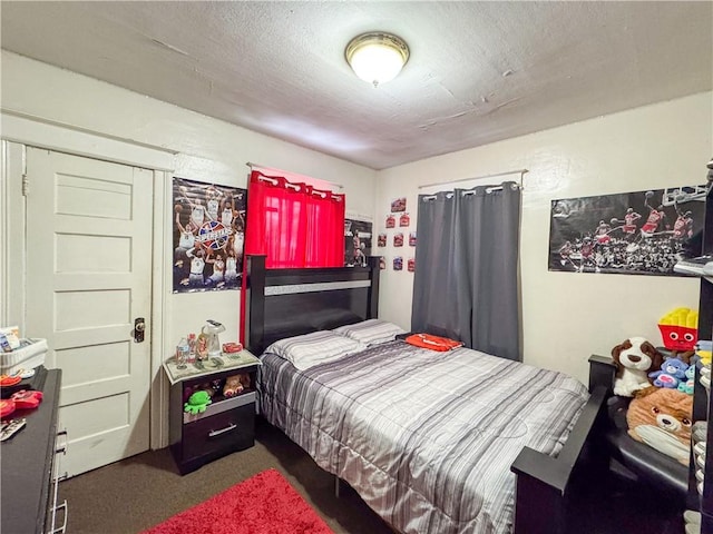 carpeted bedroom with a textured ceiling