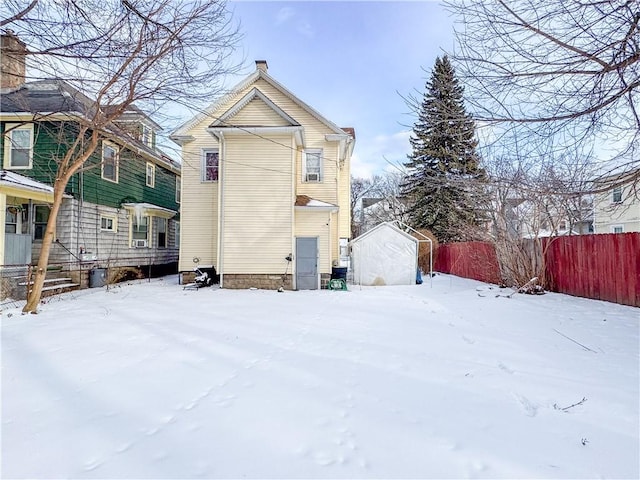 view of snow covered rear of property