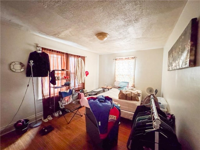 bedroom featuring hardwood / wood-style flooring and a textured ceiling