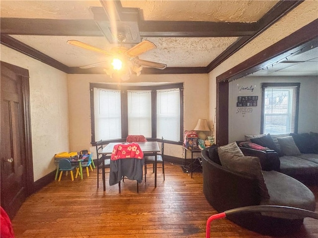 living room with ceiling fan, hardwood / wood-style floors, and a textured ceiling