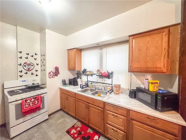 kitchen with sink and white gas range oven