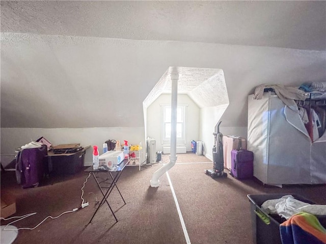 bonus room featuring carpet floors, vaulted ceiling, and a textured ceiling