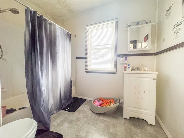 bathroom featuring toilet and a shower with shower curtain