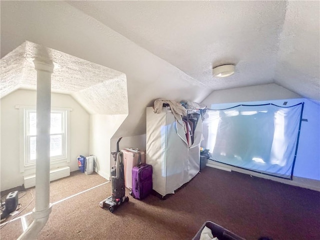 bonus room featuring vaulted ceiling, carpet floors, a textured ceiling, and ornate columns