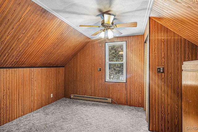 additional living space featuring carpet floors, a baseboard heating unit, and wooden walls