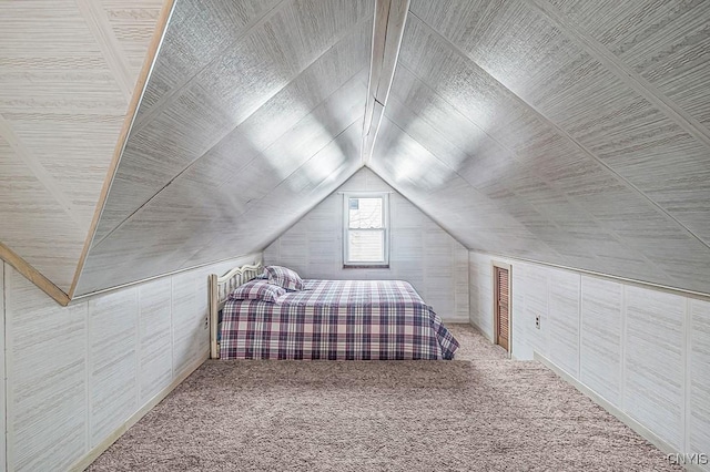 bedroom featuring lofted ceiling and carpet flooring