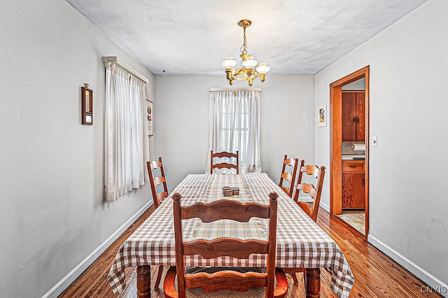 dining area with a notable chandelier and wood-type flooring