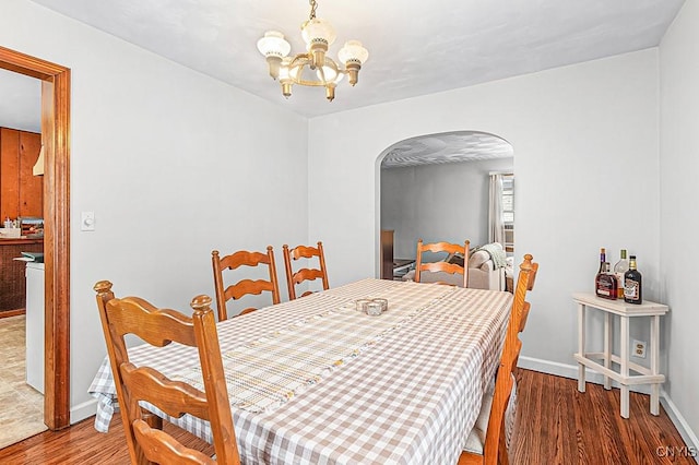 dining room with hardwood / wood-style flooring and a chandelier