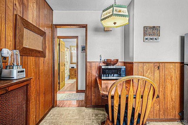 corridor featuring wood walls