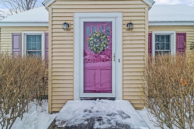 view of snow covered property entrance