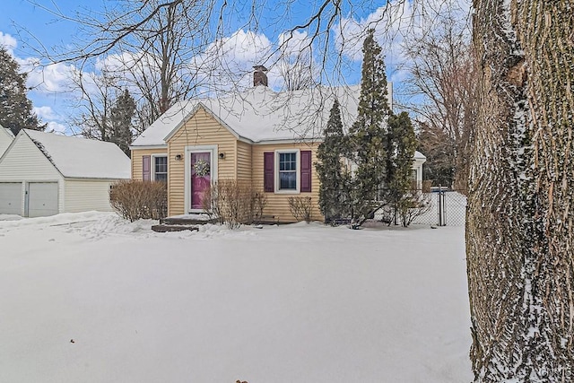 view of front of home with a garage and an outdoor structure