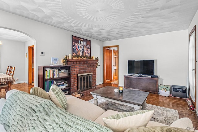 living room with a fireplace and dark hardwood / wood-style flooring