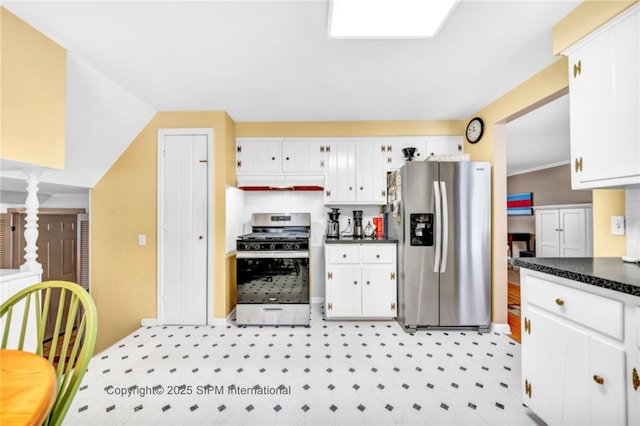 kitchen with white cabinetry, appliances with stainless steel finishes, and lofted ceiling