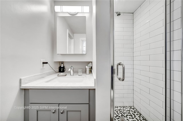 bathroom featuring vanity and a shower with door