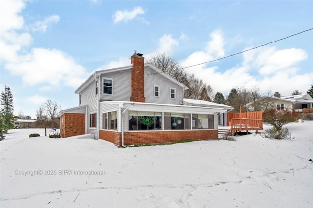 view of snow covered back of property