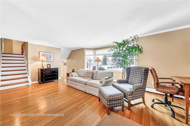 living room with hardwood / wood-style floors and crown molding