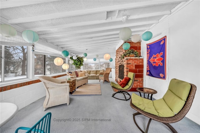 sunroom featuring lofted ceiling with beams