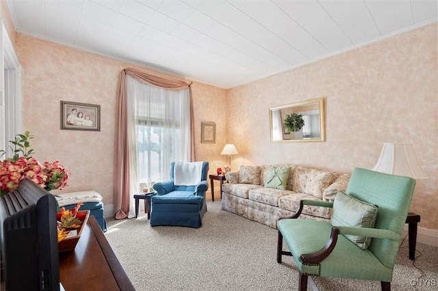 carpeted living room with ornamental molding