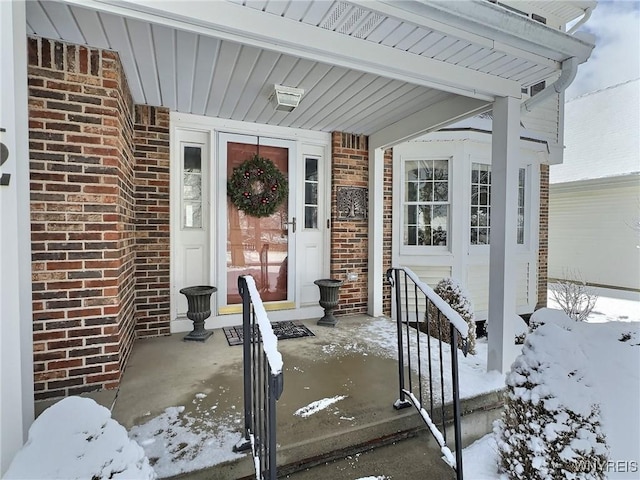 view of snow covered property entrance