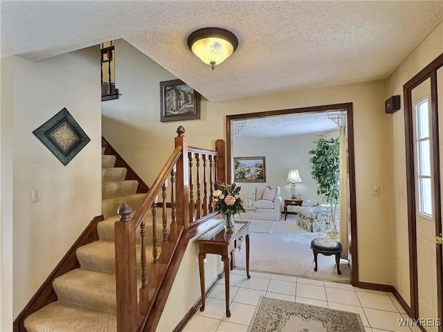 tiled foyer entrance with a textured ceiling