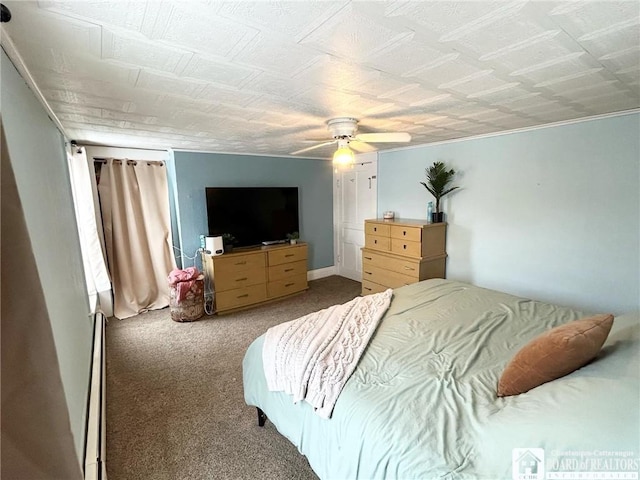 bedroom featuring baseboard heating, ceiling fan, and carpet flooring