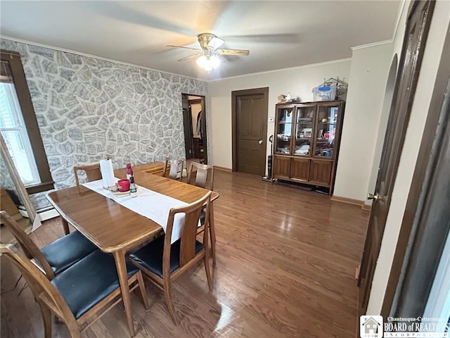 dining space featuring ornamental molding, dark wood-type flooring, and ceiling fan