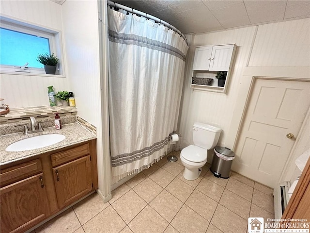 bathroom with vanity, tile patterned floors, toilet, and walk in shower