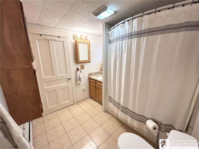 bathroom featuring vanity, toilet, and tile patterned flooring